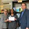 Chairman Baxter Sharp and Executive Director present check to Beverly Chapple, Monroe County Single Parent Scholarship Fund, Giving Tree grant recipient.